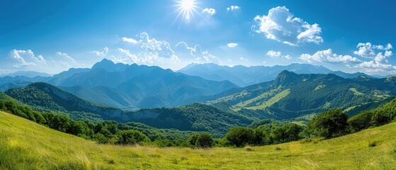 Majestic Panoramic View of Sunlit Mountain Range Beneath Clear Blue Sky