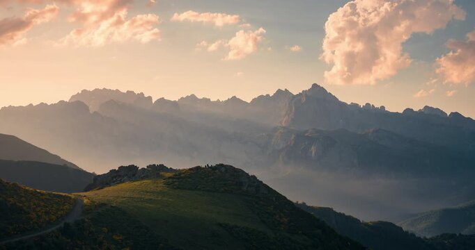 View of Picos de Europa Mountain Range with beautifull golden light rays during sunset view from collado de Llesba in Northern Spain, Cantabria.