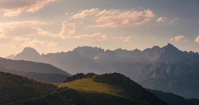 View of Picos de Europa Mountain Range with beautifull golden light rays during sunset view from collado de Llesba in Northern Spain, Cantabria.