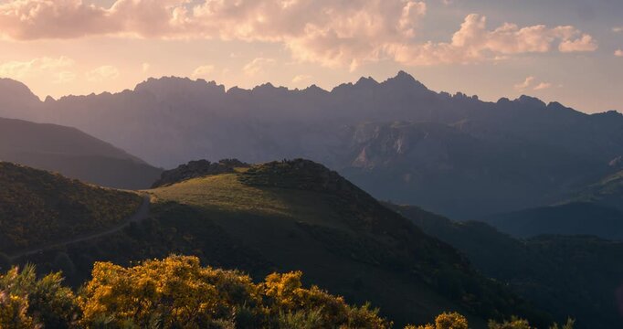 Tilt up timelapse View of Picos de Europa Mountain Range with beautifull golden light rays during sunset view from collado de Llesba in Northern Spain, Cantabria.