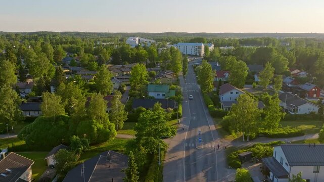 Drone rising along a quiet street in the suburbs of Helsinki, summer in Finland
