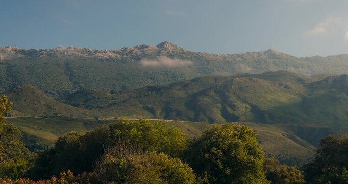 Sierra de Cuera view from Andrin, llanes during a sunny afternoon with low clouds and beautiful light playing with the mountains.