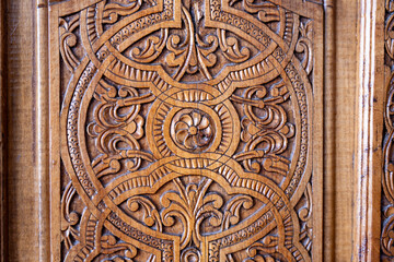 The wood carving has a lot of detail and is very ornate