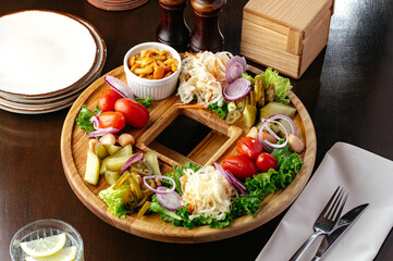 pickled vegetables on a wooden plate. restaurant menu