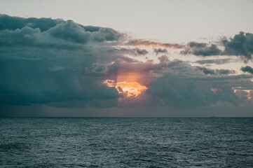 Morning view in Savona with a cloudy sky and orange sunrise.