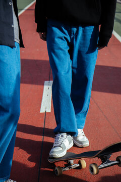 Teenagers with skateboards on a track.