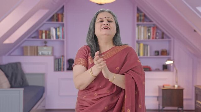 Happy Indian old woman clapping and appreciating