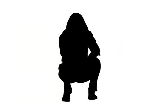 backt view of a girl's silhouette squatting