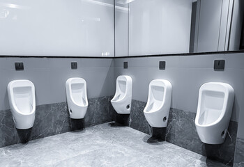 Men's room with white porcelain urinals