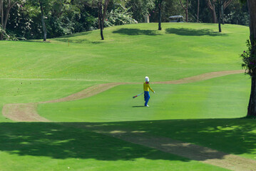 Caddy on fairway at country club golf course. lifestyle sport training golfing at golf club on summer holiday vacation.