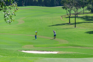 Obraz premium Caddy on fairway at country club golf course. lifestyle sport training golfing at golf club on summer holiday vacation.