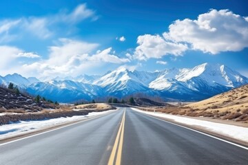 Fototapeta premium Straight asphalt highway road and snow mountains with sky clouds natural landscape. car background with generative ai