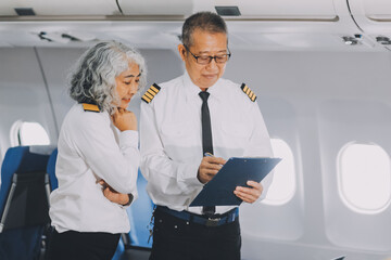 Professional pilot woman in uniform has teamwork meeting for success flight in aviation business. Young female captain instructor sitting in office and working or training commercial airline crew. © ARMMY PICCA