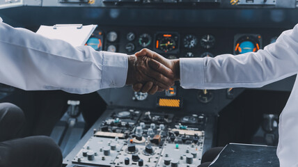 Professional pilot woman in uniform has teamwork meeting for success flight in aviation business. Young female captain instructor sitting in office and working or training commercial airline crew. © ARMMY PICCA