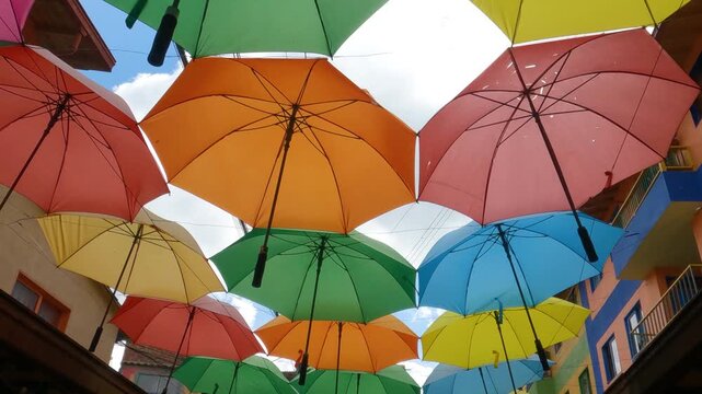 Walking Under Colorful Umbrellas in Famous Pedestrian Street in Downtown Guatape, Colombia
