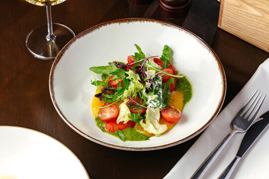 vegetable salad with pesto sauce and cheese. restaurant menu