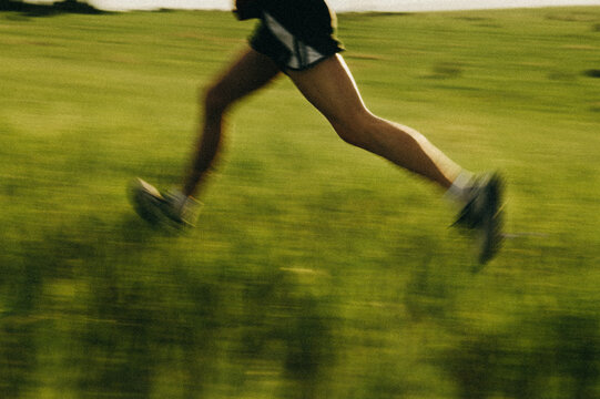 Blurred Runner in Green Meadow