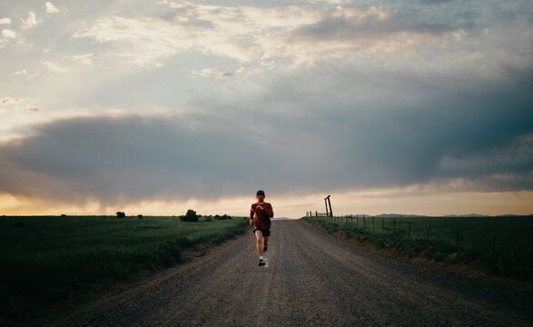 Runner Sprinting Down Dirt Road