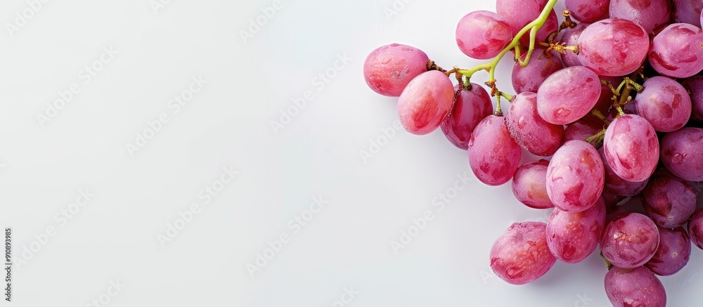 Aufkleber Pink grapes shown isolated on a white backdrop allowing space for additional text or images with a top down viewpoint in a flat lay style
