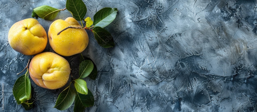 Aufkleber Fresh organic quinces with leaves on a grey table top view perfect for adding text in the copy space image