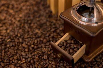 Coffee bean grinder on coffee bean background