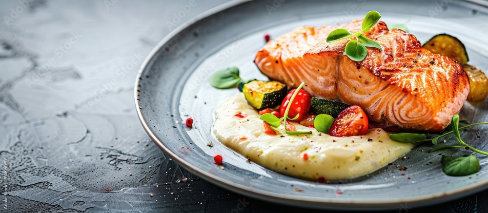 Poster salmon with a side of vegetables creatively plated on a dish with copy space image