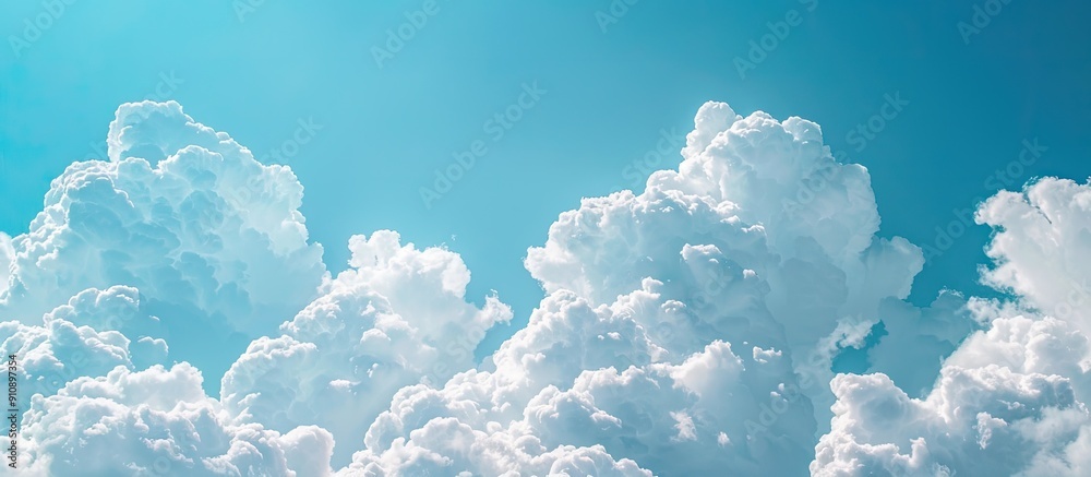 Aufkleber Picture showing stunning fluffy cumulus clouds set against a vivid blue sky with ample space for additional elements Copy space image