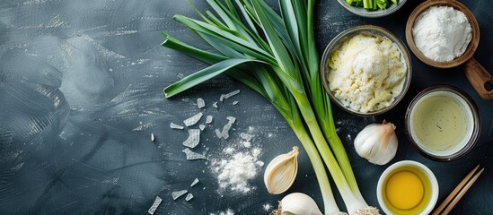 Ingredients for cooking Korean Jeon pancakes include leek and flour as shown in the copy space image