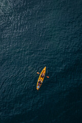 Aerial view to a people with kayak in deep blue sea