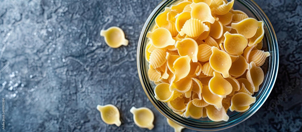 Aufkleber Raw conchiglie pasta in a jar on a table creating a pleasant layout with copy space image