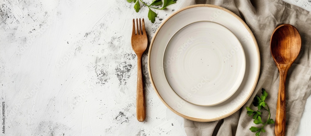 Fototapete rustic vintage dining set with a wooden spoon fork and white plate on a napkin made from water hyaci