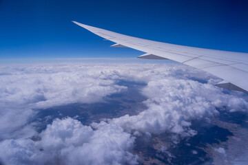 View from an airplane on a blue sky and white clouds
