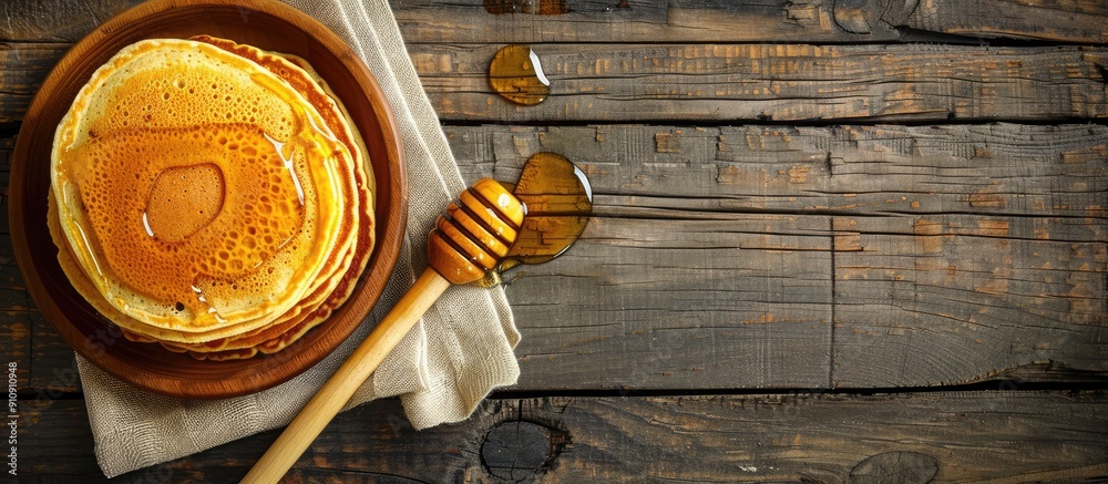 Poster wooden table with pancakes drizzled in honey featuring ample copy space image