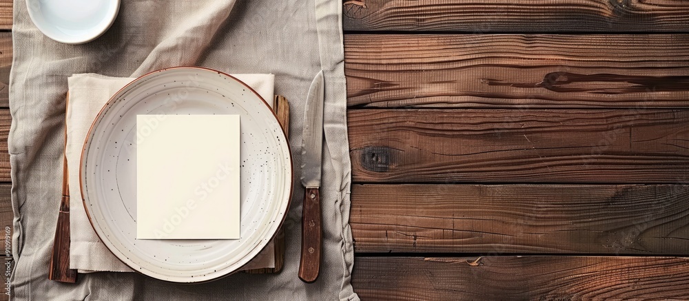 Poster Wooden table with dishes set beside empty note paper allowing for copy space image