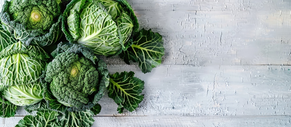 Poster organic savoy cabbage displayed on a white wooden table with copy space image