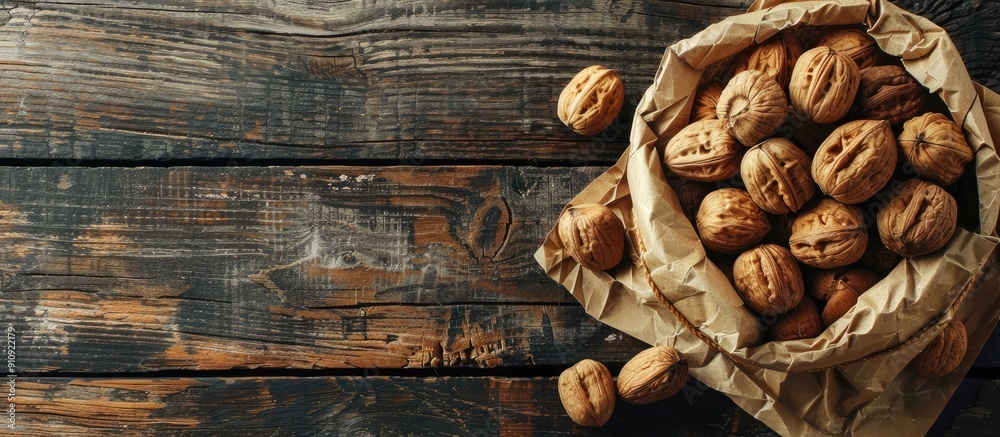 Leinwandbilder walnuts in a paper bag on an old rustic table viewed from the top with copy space image available