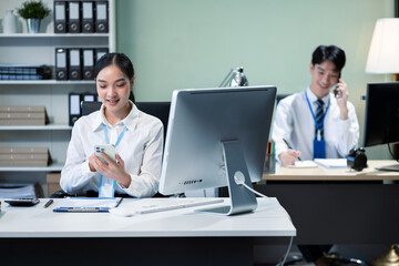 Fototapeta premium Asian employee working at office with laptop and documents on desk, People Work in Business Office.