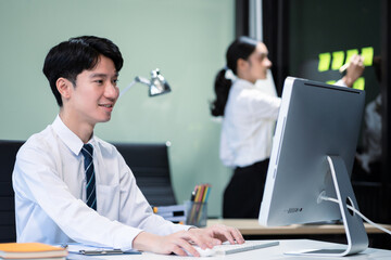 Fototapeta premium Asian employee working at office with laptop and documents on desk, People Work in Business Office.