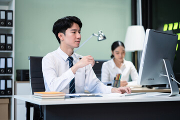 Obraz premium Asian employee working at office with laptop and documents on desk, People Work in Business Office.