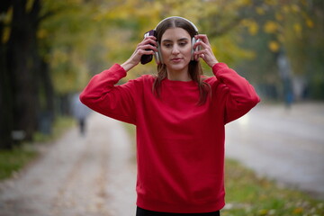 Athletic young woman taking a breath and relaxing after jogging and stretching. Woman Training and Workout Exercises On Street.