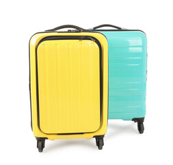 Two new yellow and light blue suitcases isolated on white