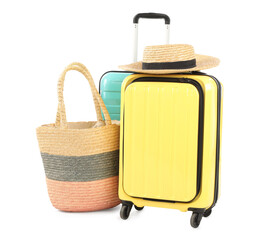 New suitcases, bag and straw hat isolated on white