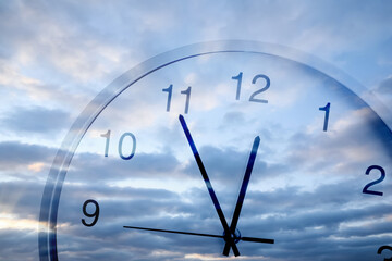 Time concept. Clock and blue sky with fluffy clouds, double exposure