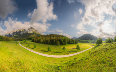 Meadow with road and bench during sunset in Berchtesgaden National Park