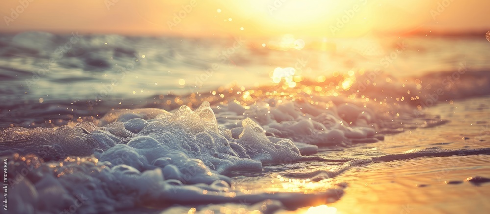 Aufkleber Sunset on a tropical beach with soft waves and blurred sunlight in the background ideal for a business summer vacation concept with vintage filter style and ample copy space image