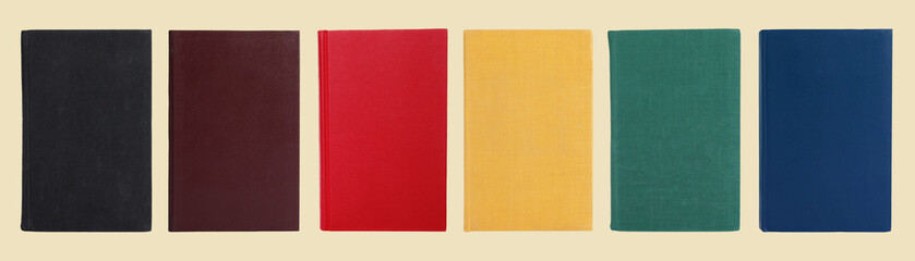 Many books with colorful hardcovers on beige background, set