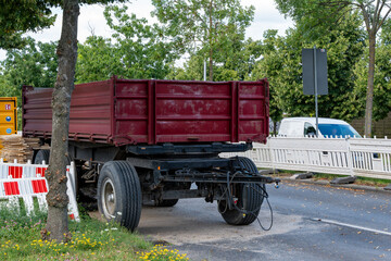 Obraz premium A cargo trailer is located at a road repair construction site. Close-up of the cargo trailer.