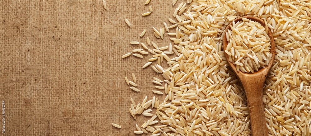Poster Top view of a wooden spoon with cereal on uncooked brown rice providing space for text in the image. Creative banner. Copyspace image