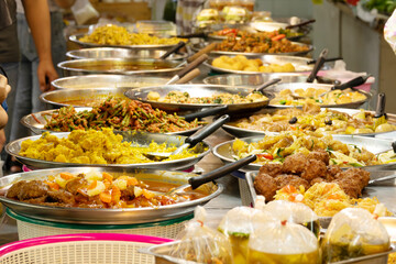 A table full of food with a lot of different dishes. The table is set up for a buffet