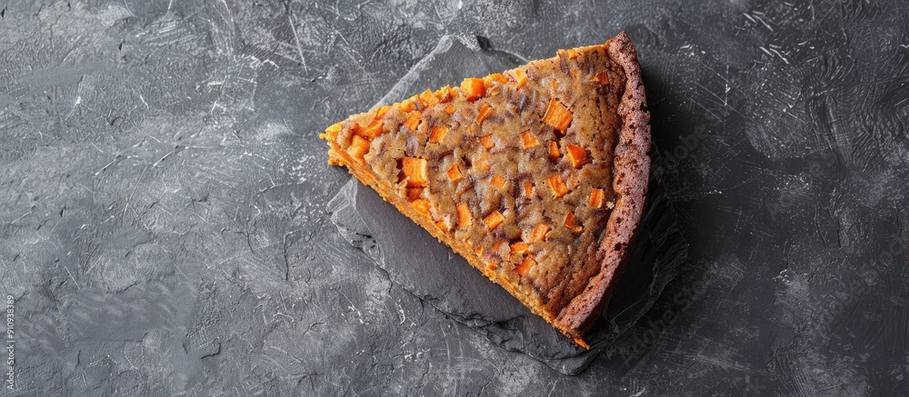 Aufkleber Top view of a vegan raw carrot cake on a gray stone surface with copy space and selective focus showcasing a slice of healthy homemade cake